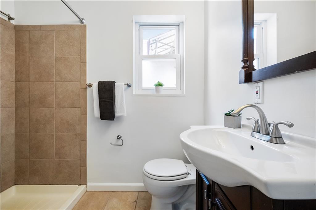 4088 Howley Street Pittsburgh, PA 15224 - Photo 20 of 32 a bathroom with a sink a toilet and mirror