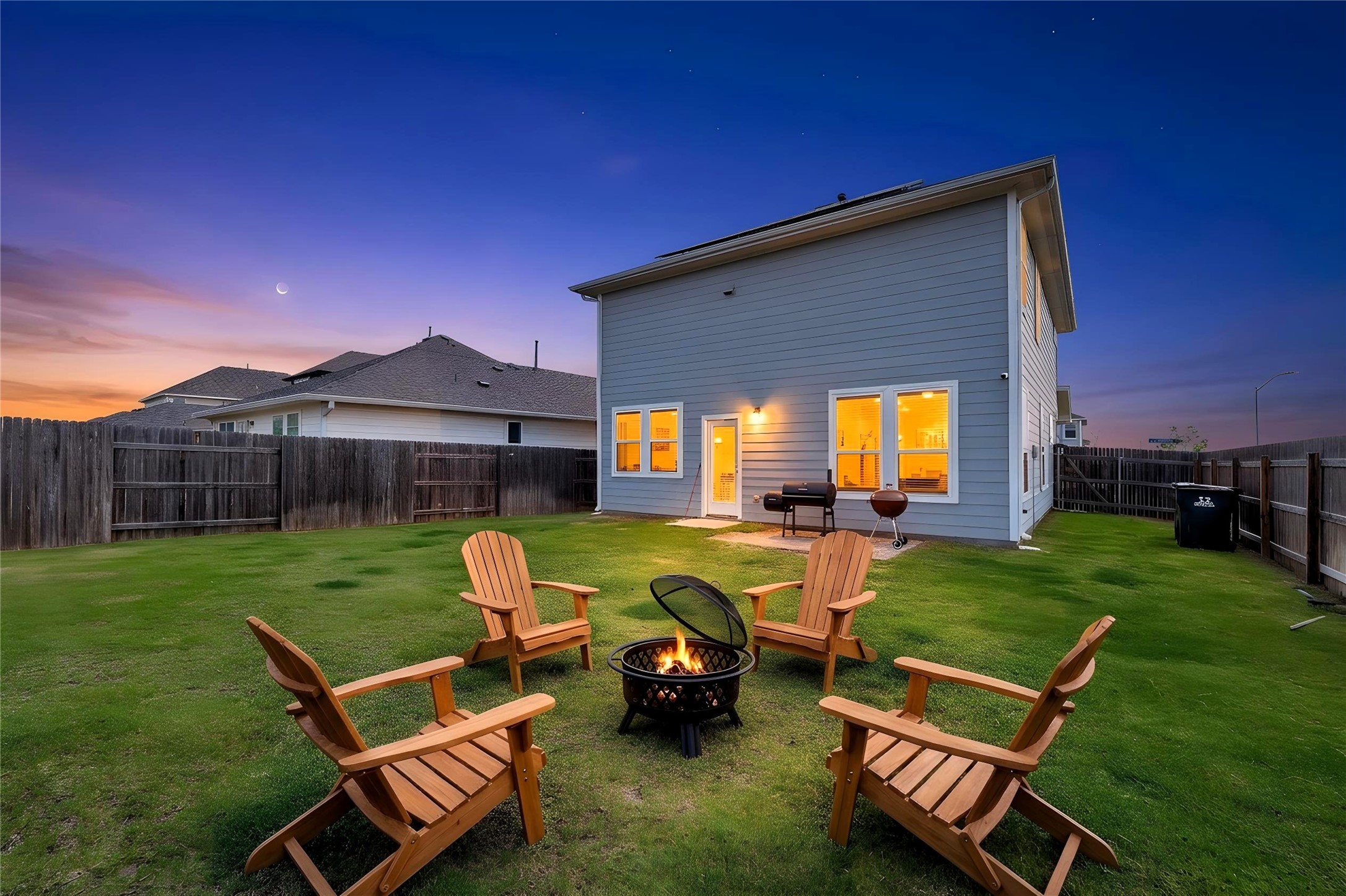 101 Crescent Street Georgetown, TX 78626 - Photo 2 of 39 Virtually staged - A well-maintained yard offers a fire pit, ideal for evening gatherings under a vivid sky.