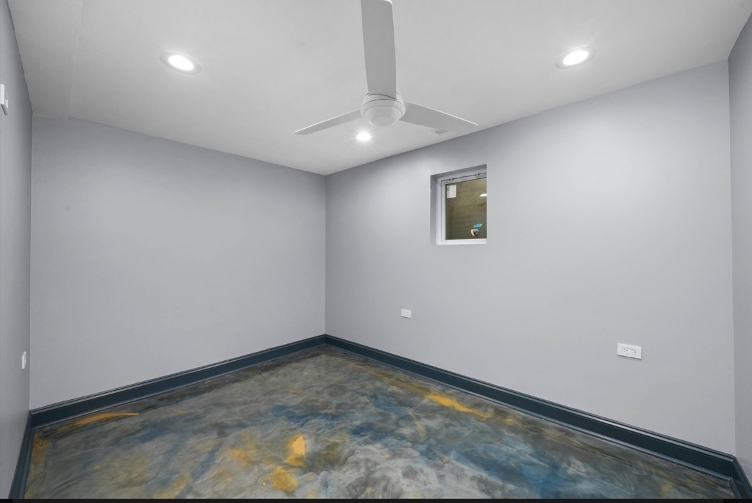 1526 South St Louis Avenue, Unit G Chicago, IL 60623 - Photo 11 of 13 an empty room with a ceiling fan and window