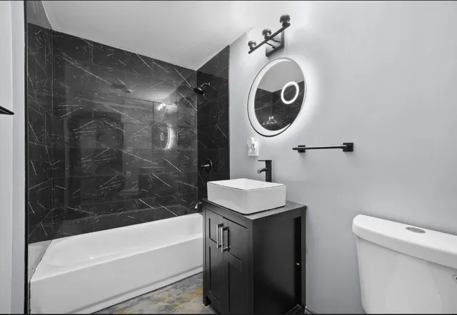 a bathroom with a sink a toilet and bathtub