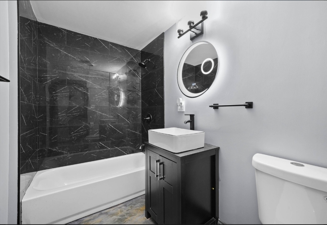 1526 South St Louis Avenue, Unit G Chicago, IL 60623 - Photo 12 of 13 a bathroom with a sink a toilet and bathtub