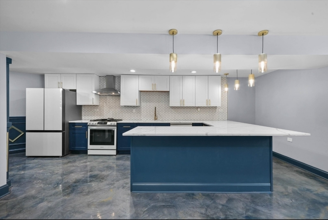 1526 South St Louis Avenue, Unit G Chicago, IL 60623 - Photo 2 of 13 a kitchen with kitchen island a sink stainless steel appliances and cabinets