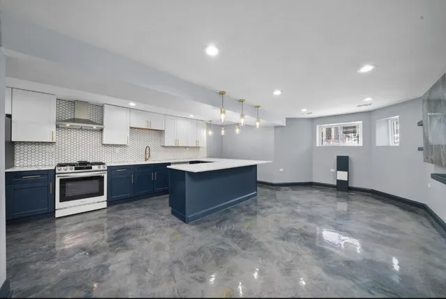 a large kitchen with stainless steel appliances and a stove top oven