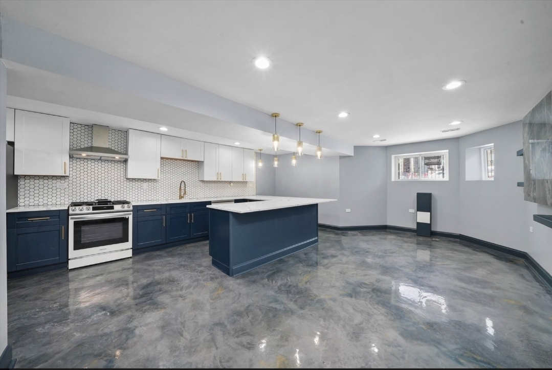 1526 South St Louis Avenue, Unit G Chicago, IL 60623 - Photo 3 of 13 a large kitchen with stainless steel appliances and a stove top oven