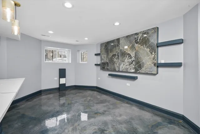 a view of a hallway with paintings on the wall