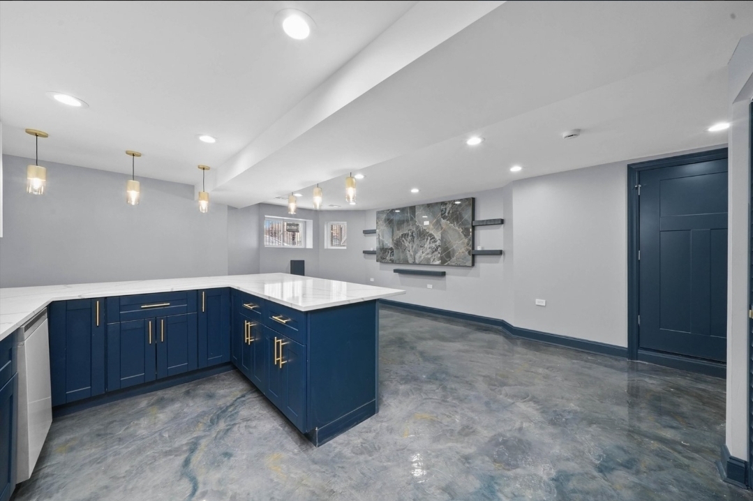 1526 South St Louis Avenue, Unit G Chicago, IL 60623 - Photo 6 of 13 a large kitchen with stainless steel appliances granite countertop a large counter top and a wooden cabinets