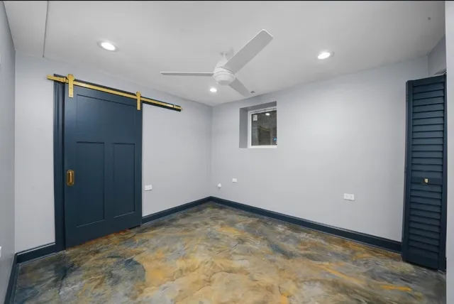 an empty room with closet and windows