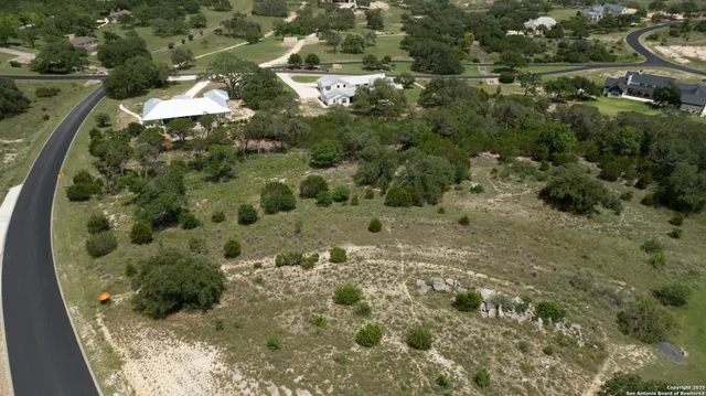 a view of a field of grass and trees