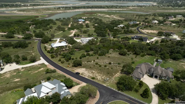 a view of a lake with lawn chairs