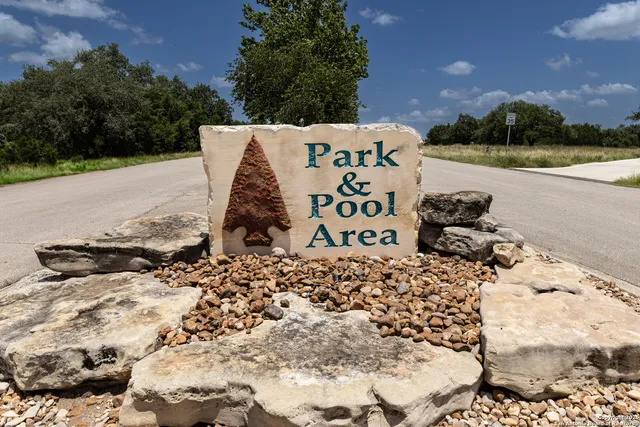 an aerial view of a house with a yard and lake view