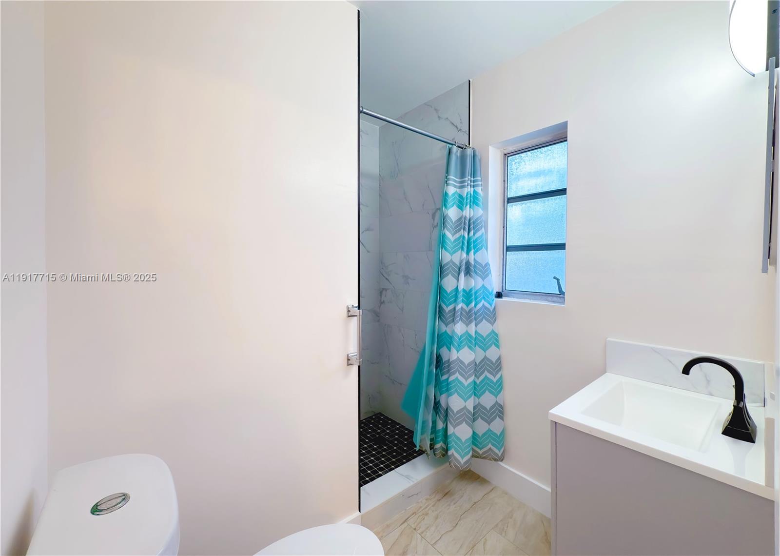 1021 Southwest 3rd Street, Unit 3 Miami, FL 33130 - Photo 8 of 9 a bathroom with a sink and a mirror