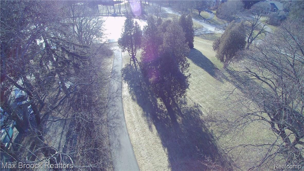 4905 Charing Cross Road Bloomfield Hills, MI 48304 - Photo 53 of 59 driveway leads down to the beautiful pond where fishing and ice skating awaits.