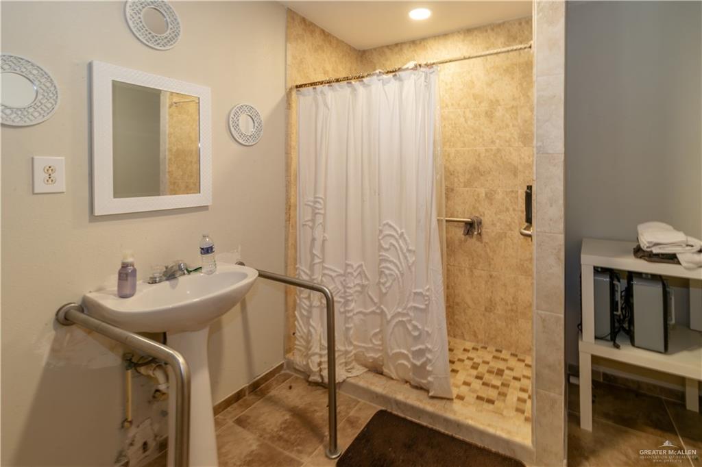 24724 Iowa Road Edinburg, TX 78541 - Photo 4 of 18 a bathroom with a sink and a mirror