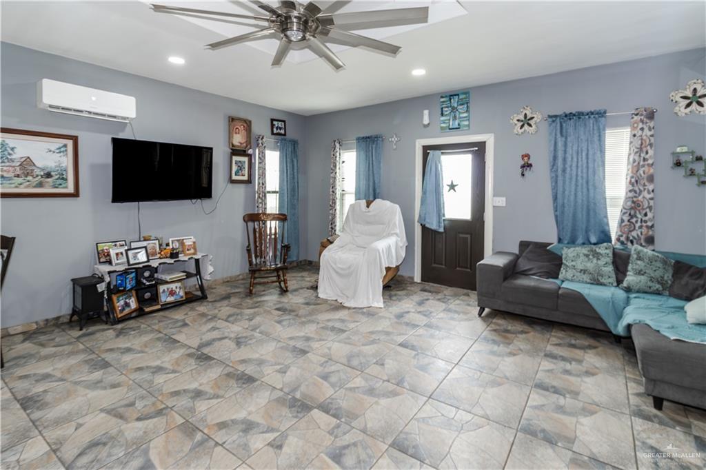 24724 Iowa Road Edinburg, TX 78541 - Photo 7 of 18 a living room with furniture and a flat screen tv