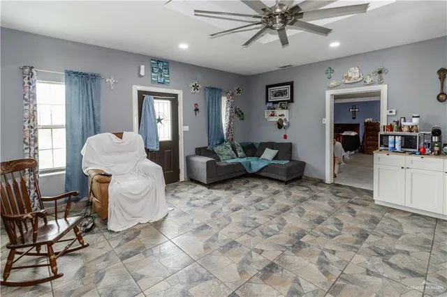 a living room with furniture and white walls