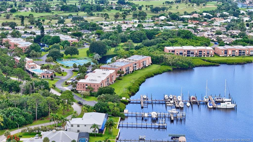 3100 Southeast Pruitt Road, Unit B105 Port St. Lucie, FL 34952 - Photo 1 of 40 an aerial view of a house with a garden and lake view
