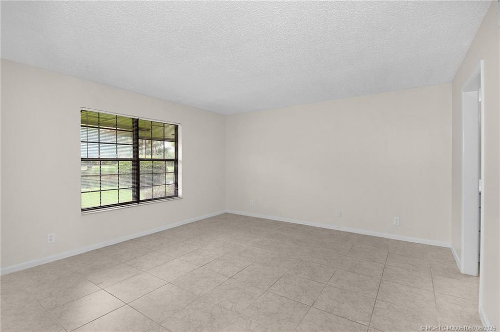 3100 Southeast Pruitt Road, Unit B105 Port St. Lucie, FL 34952 - Photo 11 of 40 an empty room with windows