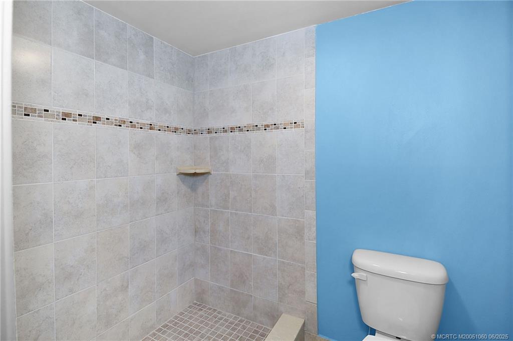 3100 Southeast Pruitt Road, Unit B105 Port St. Lucie, FL 34952 - Photo 17 of 40 a bathroom with a toilet and a shower