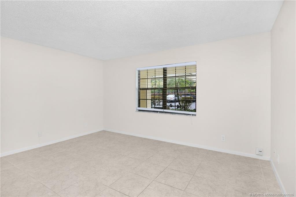 3100 Southeast Pruitt Road, Unit B105 Port St. Lucie, FL 34952 - Photo 19 of 40 an empty room with windows