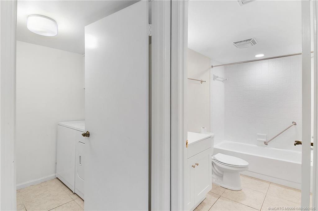 3100 Southeast Pruitt Road, Unit B105 Port St. Lucie, FL 34952 - Photo 20 of 40 a bathroom with a granite countertop toilet a sink and shower