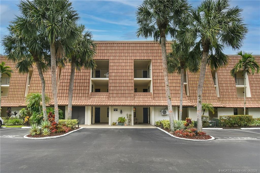 3100 Southeast Pruitt Road, Unit B105 Port St. Lucie, FL 34952 - Photo 2 of 40 a front view of a building with small garden
