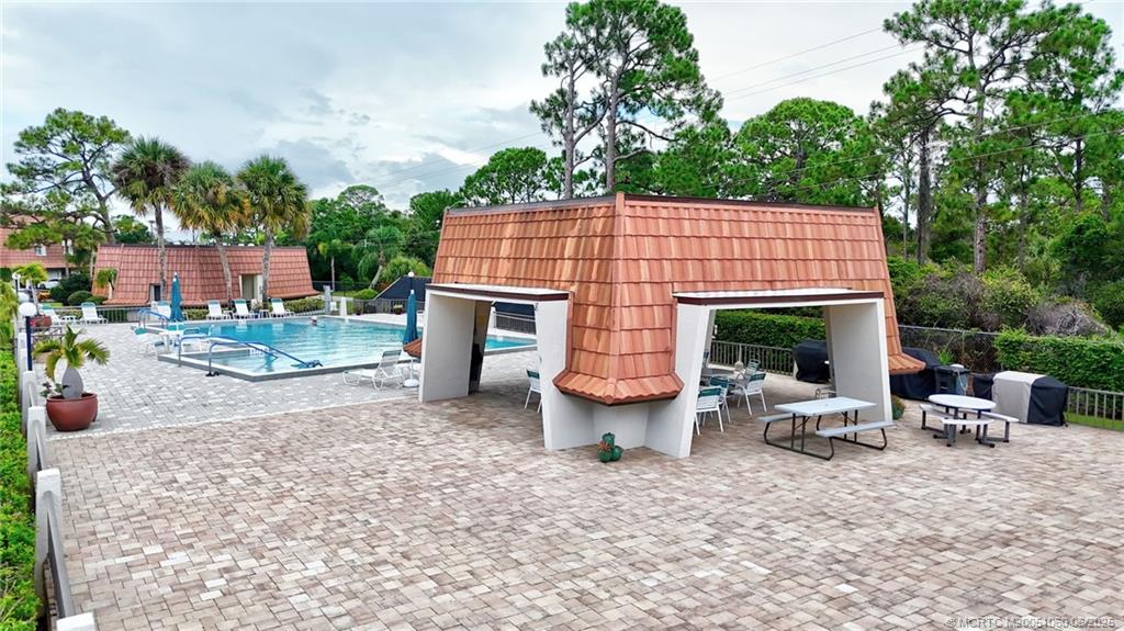 3100 Southeast Pruitt Road, Unit B105 Port St. Lucie, FL 34952 - Photo 24 of 40 an outdoor space with furniture and garden