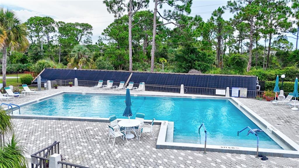 3100 Southeast Pruitt Road, Unit B105 Port St. Lucie, FL 34952 - Photo 26 of 40 a view of a backyard with swimming pool