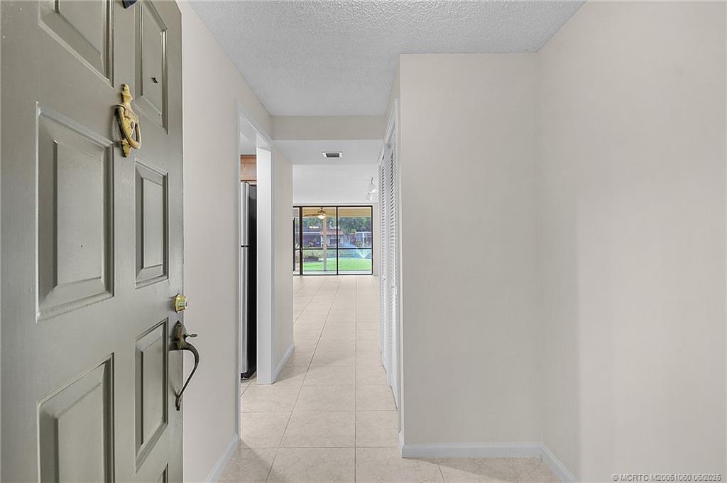 3100 Southeast Pruitt Road, Unit B105 Port St. Lucie, FL 34952 - Photo 3 of 40 a view of a hallway with a shower