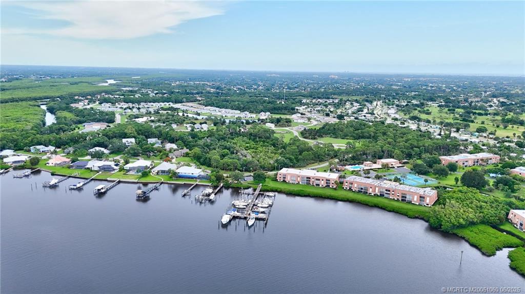 3100 Southeast Pruitt Road, Unit B105 Port St. Lucie, FL 34952 - Photo 33 of 40 an aerial view of a city with lots of residential buildings and mountain view in back