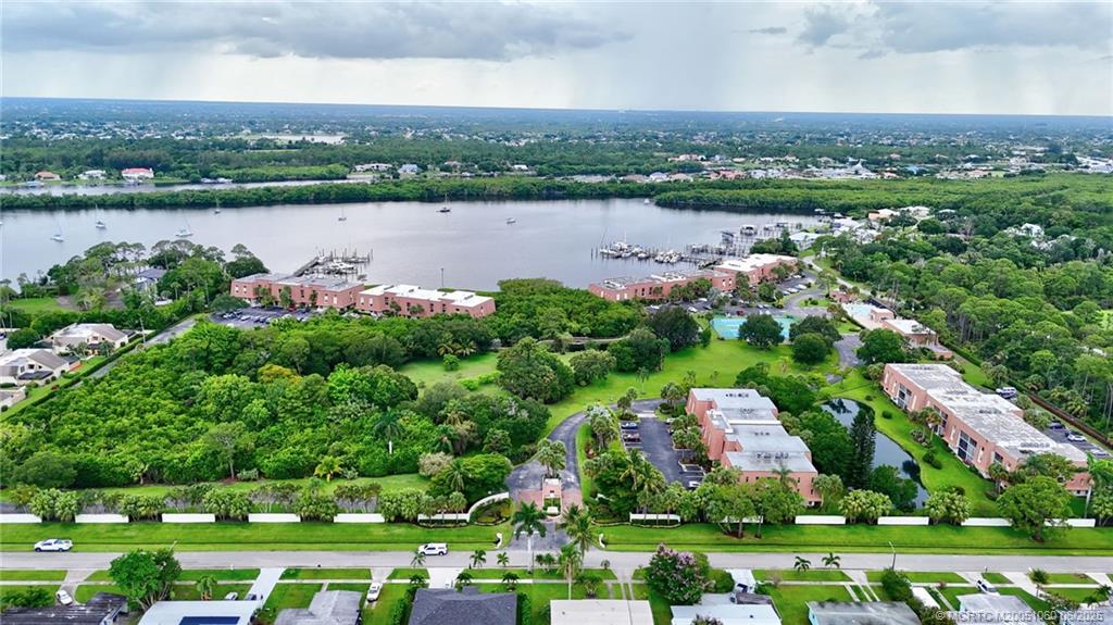 3100 Southeast Pruitt Road, Unit B105 Port St. Lucie, FL 34952 - Photo 36 of 40 an aerial view of a city with lots of residential buildings and lake view in back