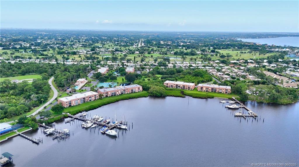 3100 Southeast Pruitt Road, Unit B105 Port St. Lucie, FL 34952 - Photo 38 of 40 an aerial view of a house with a yard and lake view