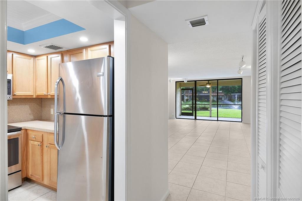 3100 Southeast Pruitt Road, Unit B105 Port St. Lucie, FL 34952 - Photo 5 of 40 a white refrigerator freezer sitting in a kitchen