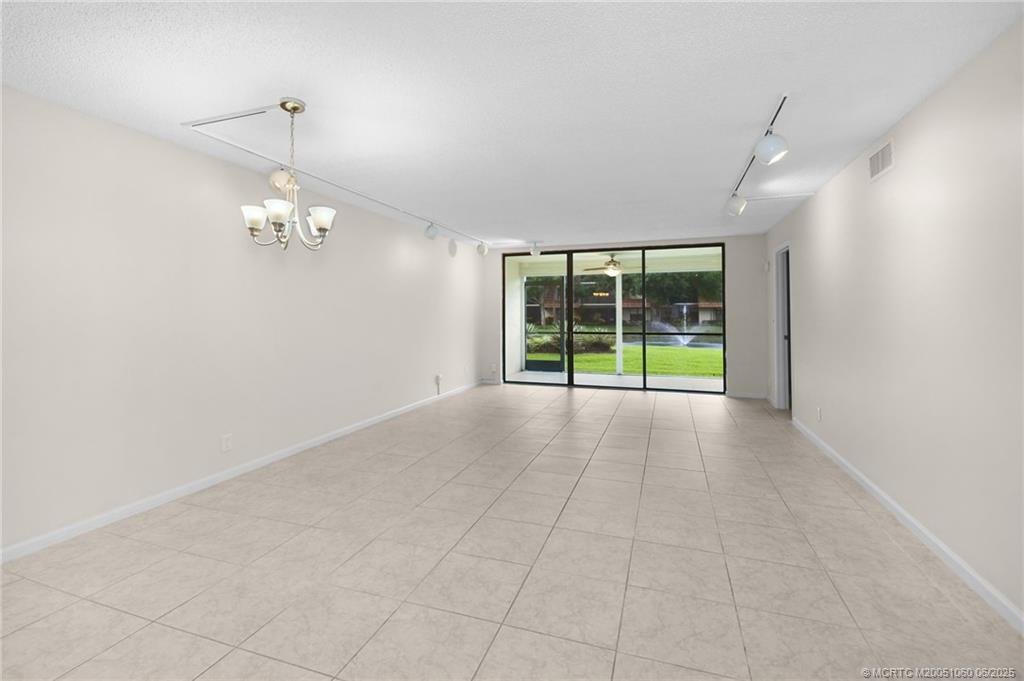 3100 Southeast Pruitt Road, Unit B105 Port St. Lucie, FL 34952 - Photo 9 of 40 a view of an empty room with a window