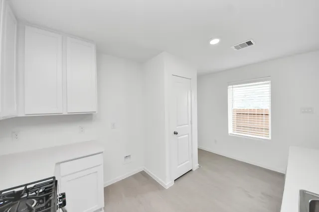 a view of an empty room and closet area