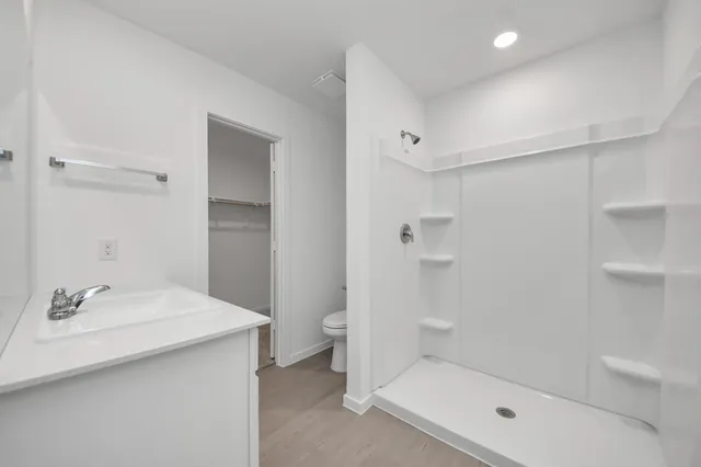 a bathroom with a sink a light fixture a vanity and a mirror