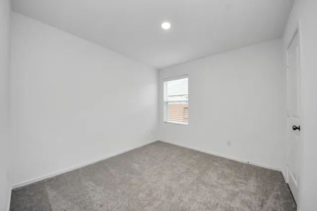 a view of an empty room and a window