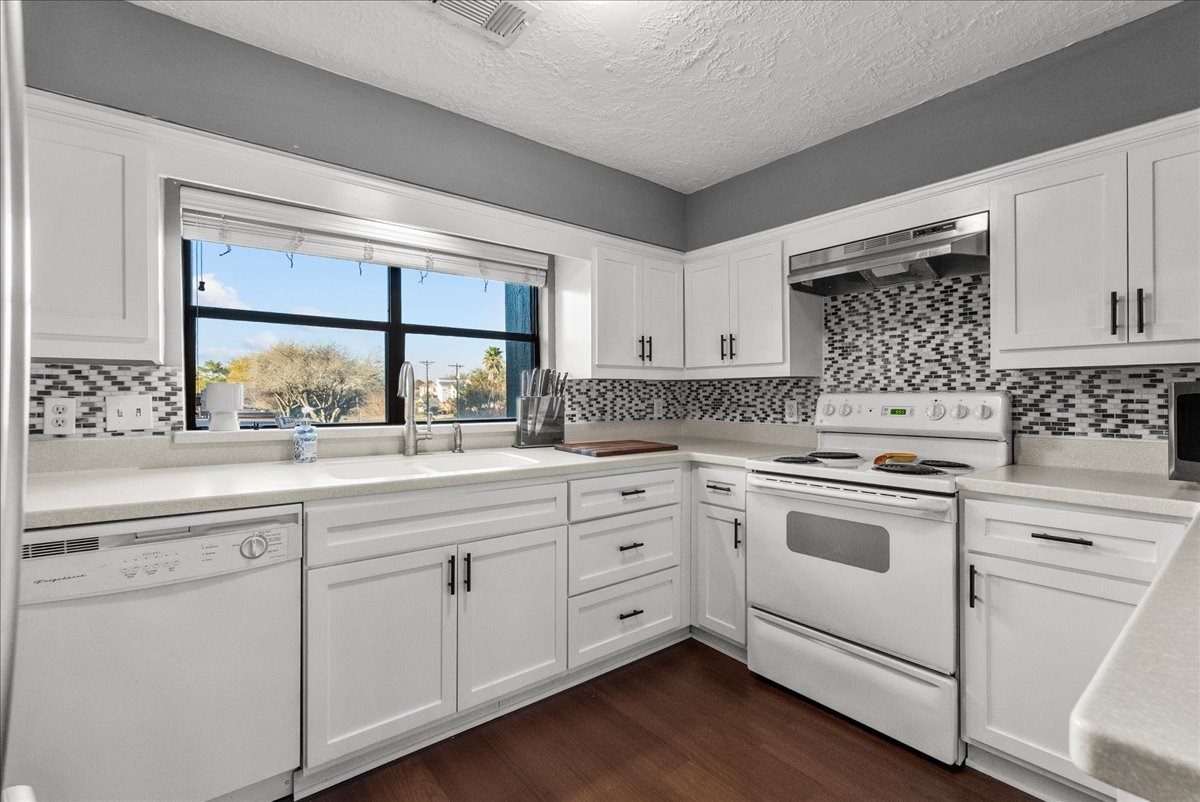 671 Davis Road League City, TX 77573 - Photo 16 of 38 a kitchen with white cabinets sink and window