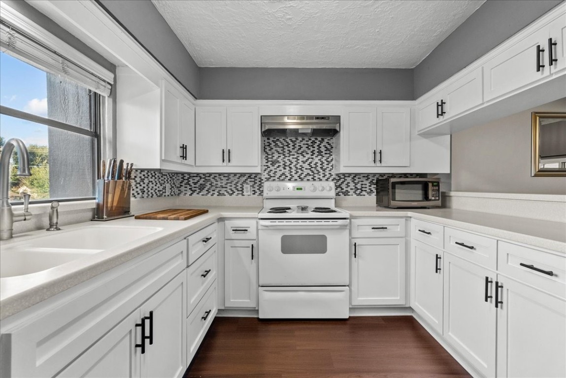 671 Davis Road League City, TX 77573 - Photo 18 of 38 a kitchen with granite countertop white cabinets and white appliances