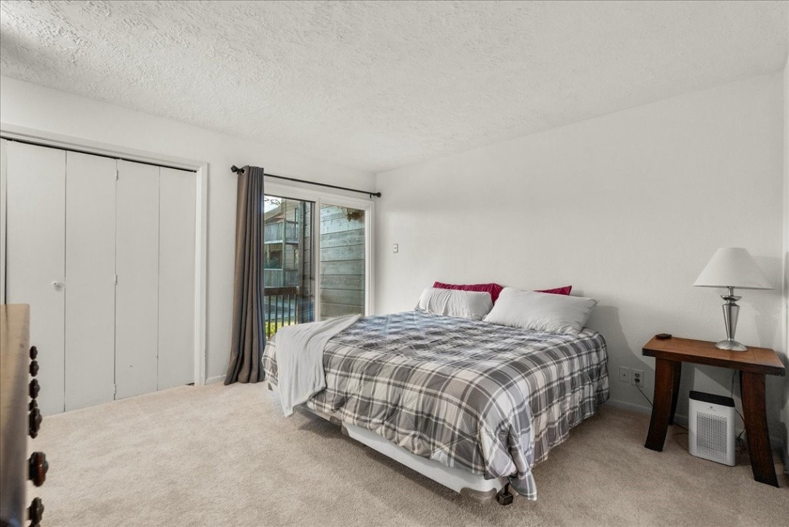 671 Davis Road League City, TX 77573 - Photo 21 of 38 a bedroom with a bed lamp and a closet