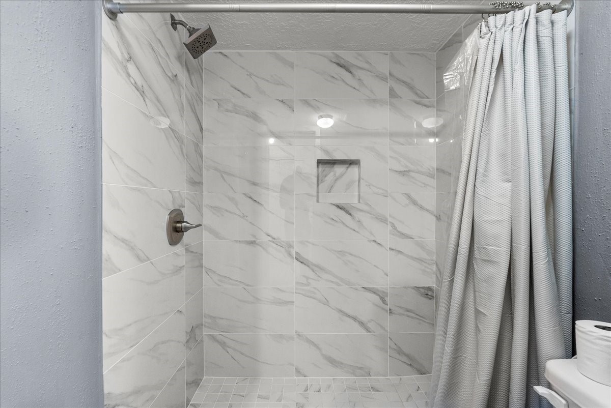 671 Davis Road League City, TX 77573 - Photo 24 of 38 a bathroom with a shower