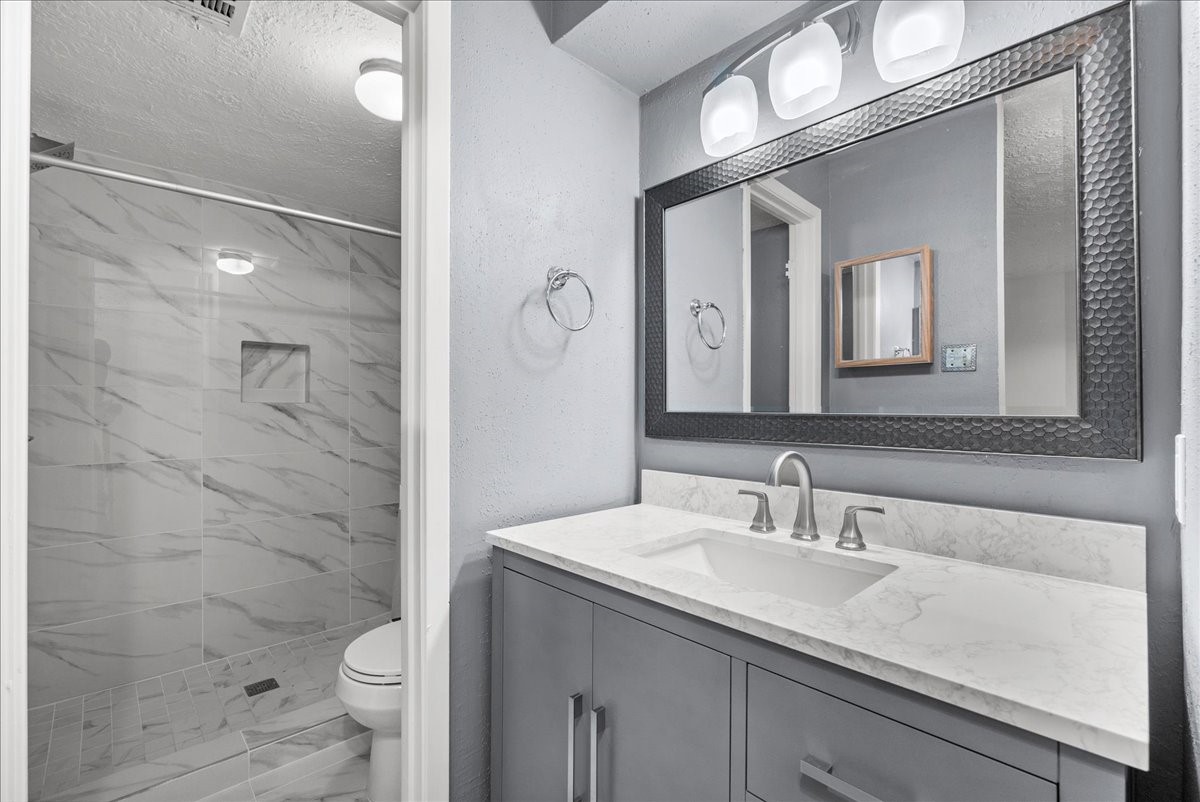 671 Davis Road League City, TX 77573 - Photo 25 of 38 a bathroom with a sink a toilet and shower