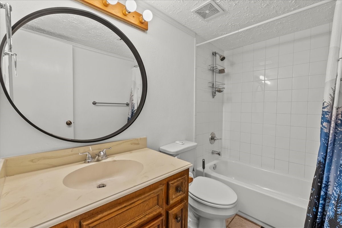 671 Davis Road League City, TX 77573 - Photo 26 of 38 a bathroom with a sink a toilet and a mirror