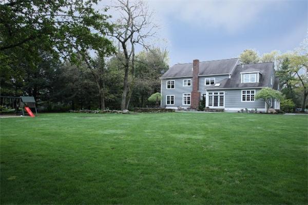 39 Sunset Road Weston, MA 02493 - Photo 8 of 8 a view of a house with a big yard and large trees