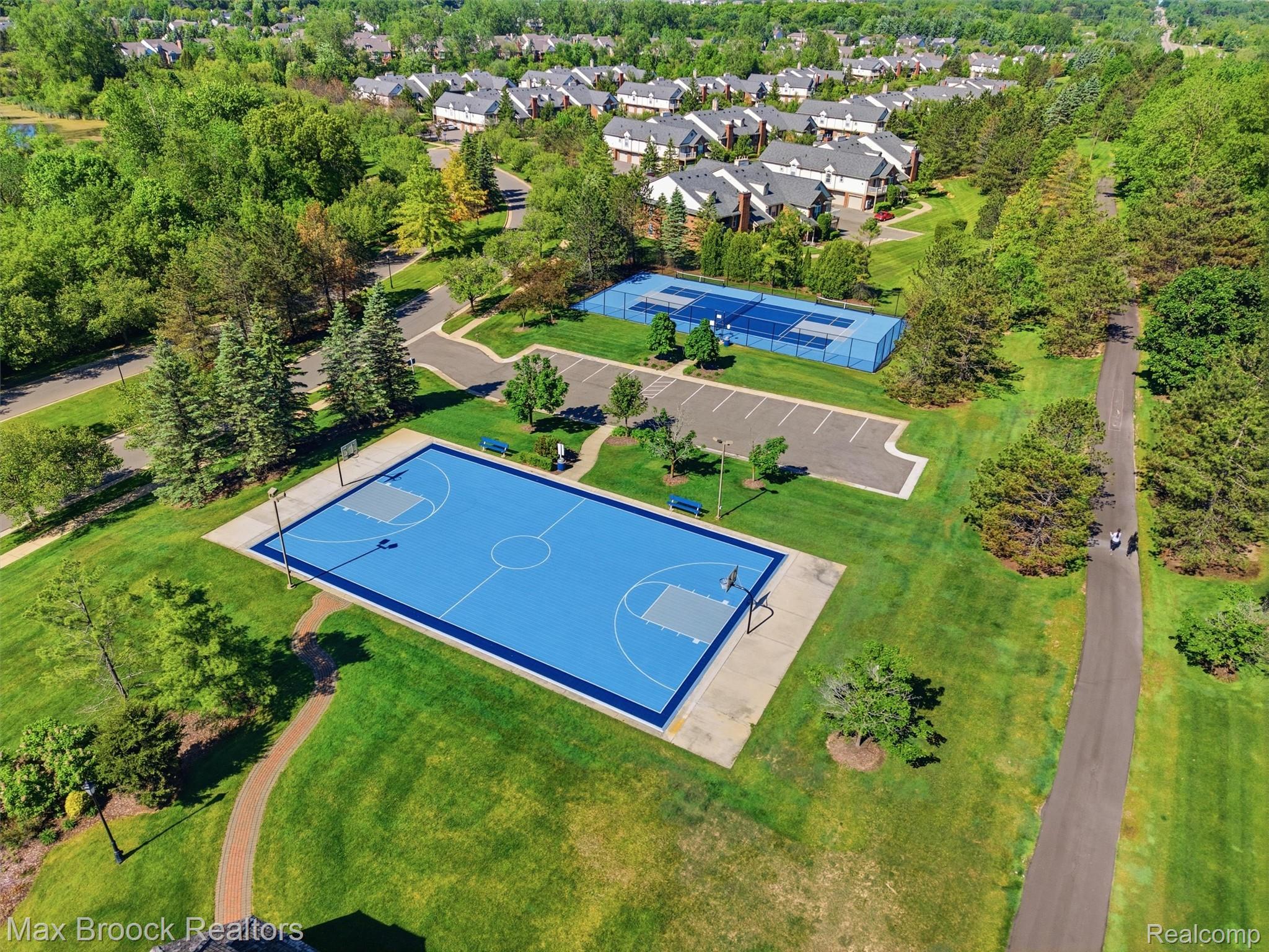 3562 Tremonte Circle Rochester, MI 48306 - Photo 33 of 33 Recreational amenities featuring a full-size basketball court, a tennis court, and an asphalt walking path surrounded by manicured lawns and mature trees