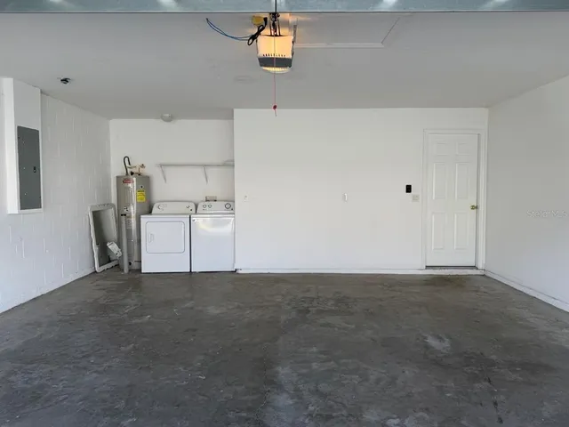 a view of a kitchen with wooden cabinet and a refrigerator