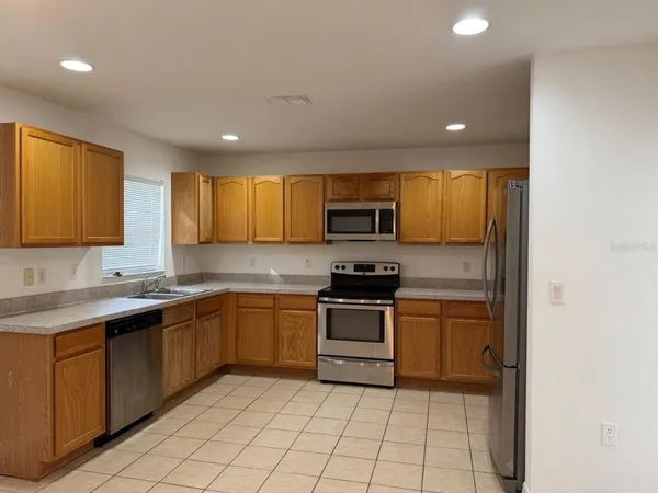 a kitchen with stainless steel appliances granite countertop a sink and cabinets
