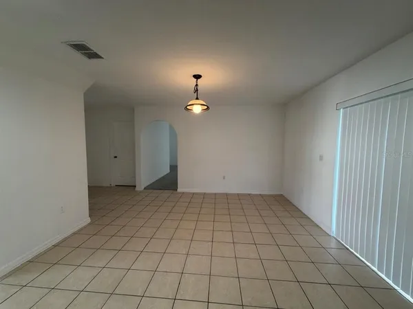 an empty room with white walls and tiles