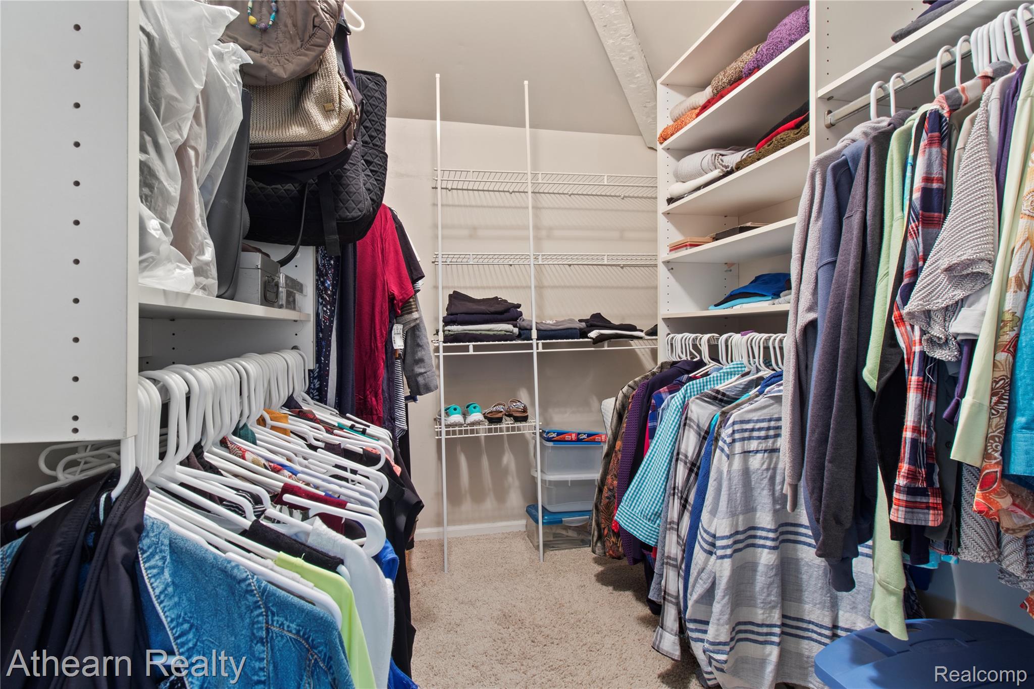 12427 Foley Road Fenton, MI 48430 - Photo 40 of 47 Expansive closet featuring carpet flooring, built-in shelving, and multiple hanging rods for organization