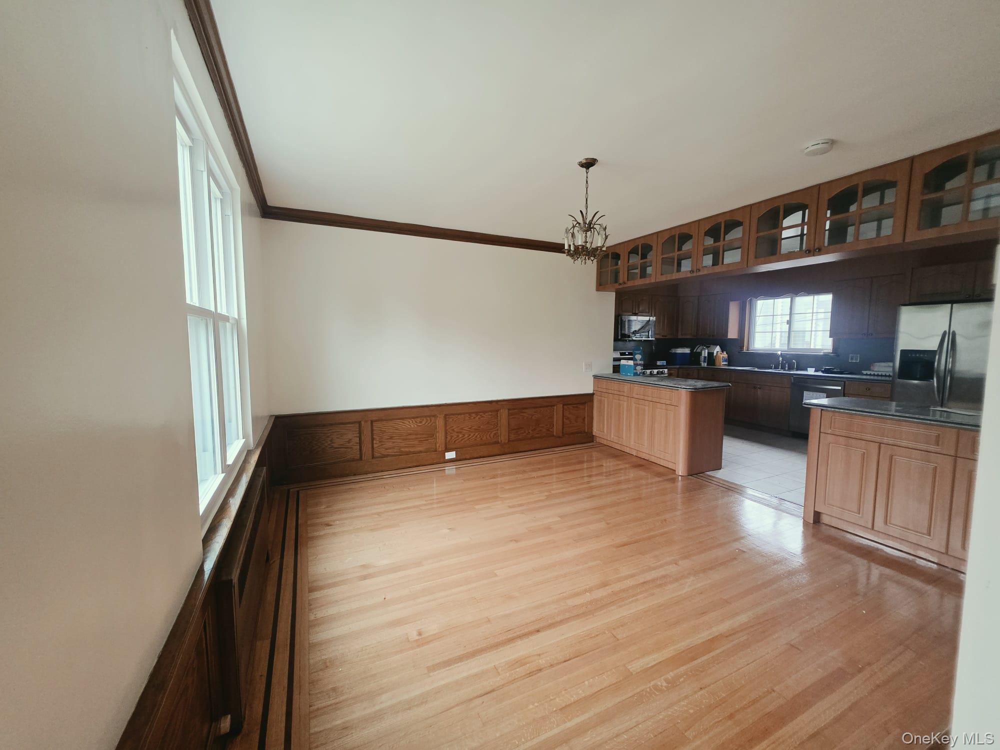 180-15 Dalny Road Queens, NY 11432 - Photo 5 of 10 a kitchen with granite countertop a stove and a wooden floor