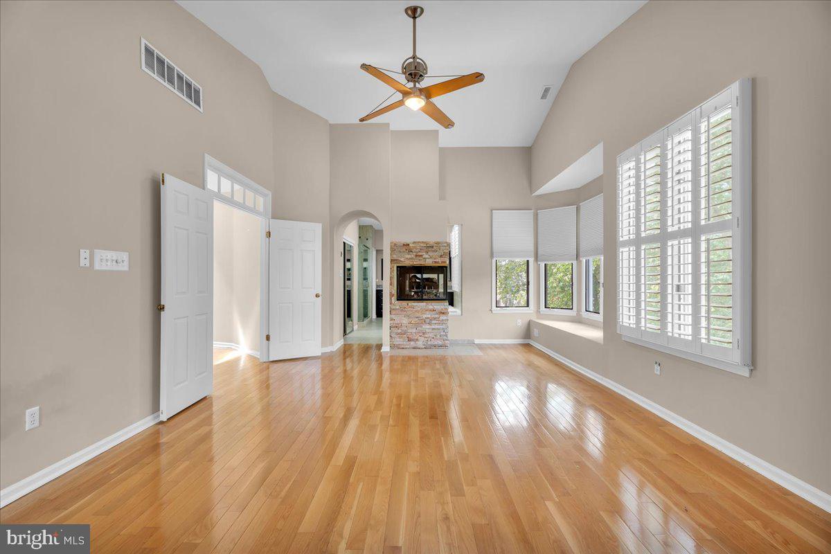 5 Promenade Place Voorhees, NJ 08043 - Photo 7 of 24 a view of a livingroom with wooden floor a ceiling fan and windows